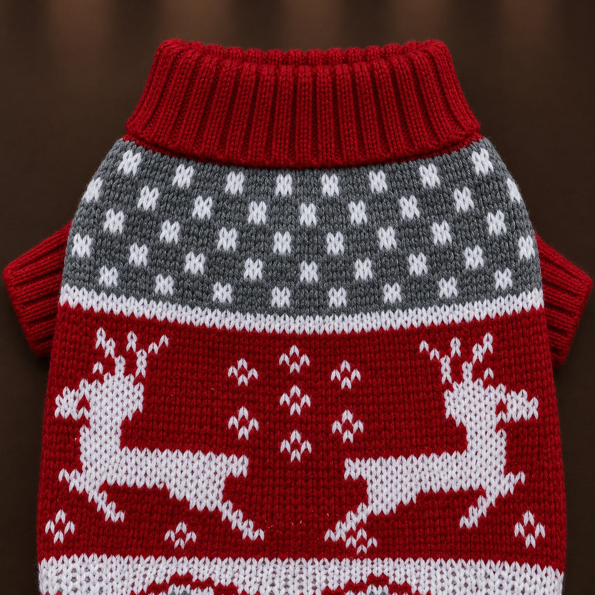 Close-up of the red sweater's ribbed turtleneck, gray dotted band and knitted white reindeer