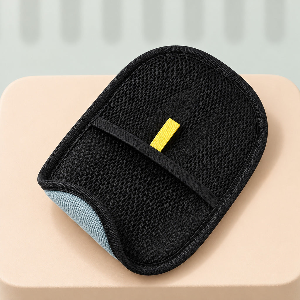 One hair remover glove, black mesh side up, with the yellow tab above the elastic band and a corner turned back to show the gray pad