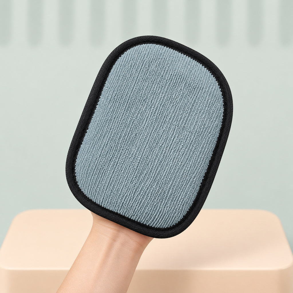 Glove held up to show its gray-blue wiping pad
